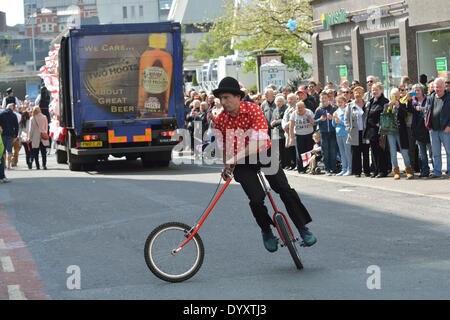 A trick cyclist  takes part in the St George's Day Parade , which passes along Oldham Street on its way through the centre of Manchester. St George's Day Parade  Manchester, UK  27th April 2014 Stock Photo