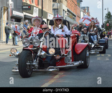 A motorbike  takes part in the St George's Day Parade , which passes along Oldham Street on its way through the centre of Manchester. St George's Day Parade  Manchester, UK  27th April 2014 Stock Photo