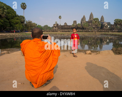 Nheam a Cambodian Buddhist Monk with his adopted son at Angkor Wat, UNESCO World Heritage Site. Siem Reap, Cambodia Stock Photo