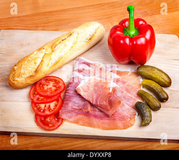 Vegetables with ham and French bread. Stock Photo