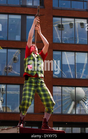 Man sword swallowing performance in Manchester, UK 27th April, 2014. Sword swallower circus performer at the St George's weekend celebrations, a family event held in Albert Square and Piccadilly, an extension of the annual St George Parade and a venture to help celebrate England's Patron Saint, with many activities & performers.  Manchester embraces the days when both national festivals and parades aim to bring the city together and provide Mancunians with an event where different national identities are celebrated. Stock Photo