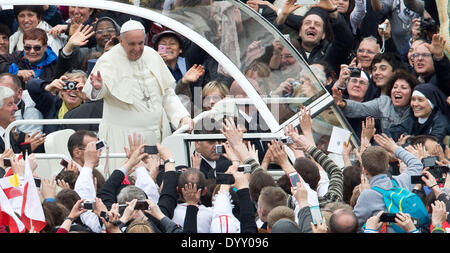 St Peter's Square, Vatican City. 27th Apr, 2014. Pope Francis stands in his Papamobil as he leaves the Canonization Service at St. Peter's Square in the Vatican, 27 April 2014. Around one million pilgrims and tourists attend the canonization of Pope John XXIII and Pope John Paul II by Pope Francis. Photo: Michael Kappeler/dpa/Alamy Live News Stock Photo