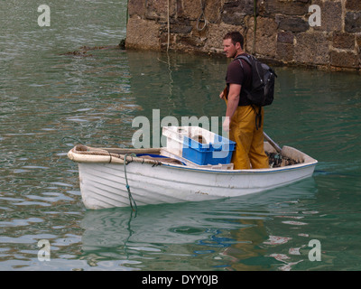 Cornish fisherman landing his catch in a dinghy, Newquay Harbour, Cornwall, UK Stock Photo