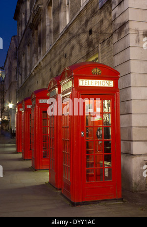 Row of red K2 telephone boxes at night Broad Court Covent Garden London England UK Stock Photo