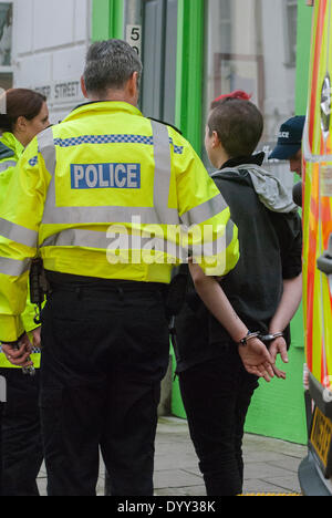 Brighton, UK. 27th Apr, 2014. A woman is detained as police escort March for England supporters to the train station after the annual demonstration along the waterfront in Brighton, United Kingdom. Credit:  Peter Manning/Alamy Live News Stock Photo