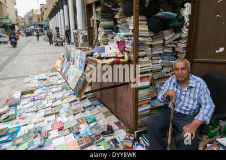 (140428) -- BAGHDAD, April 28, 2014 (Xinhua) -- The owner of an outdoor book stall waits for customers on the Mutanabbi Street, Baghdad, Iraq, April 27, 2014. Mutanabbi Street, located near the old quarter of Baghdad, is the historic center of bookselling, a street filled with bookstores and outdoor book stalls. It was named after the 10th century classical Iraqi poet Al-Mutanabbi. The street has been often referred to as the heart and soul of the Baghdad literacy and intellectual community. Mutanabbi Street was rocked by a car bombing on in March 2007 when around 30 people were killed. The go Stock Photo