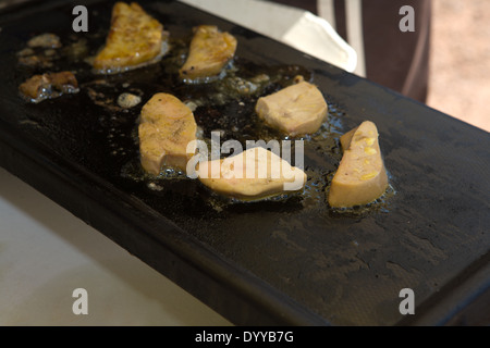 Hot grilled foie gras over bread slices with apple and strawberries jam on the top Stock Photo