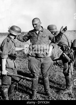 German soldiers with a prisoner on the Eastern Front, 1941 Stock Photo