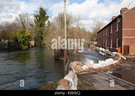 Flooded street in Winchester, Hampshire, England, UK, when the River Itchen burst its banks. Flooding is becoming more frequent with climate change. Stock Photo