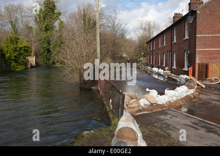 Flooded street in Winchester, Hampshire, England, UK, when the River Itchen burst its banks. Flooding is becoming more frequent with climate change. Stock Photo