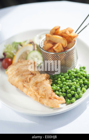 Fish and chips on a plate with peas. Stock Photo