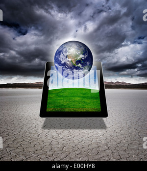 Digital composite of a digital tablet with the earth Stock Photo