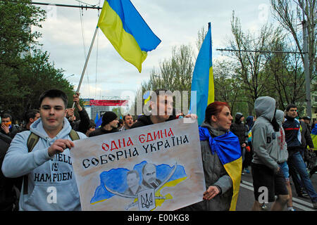 Donetsk, Ukraine. 28th Apr, 2014. A large part of the Ukranian population of Donetsk has gathered today to rally in favor of an european Ukraine and against the russian occupation.  The parade started in front all'Olimpisky Stadium, a few minutes after starting the procession, joyous and colorful, was attacked by pro-Russian activists with stones and bombs, the police made sure to calm everyone down, but if the pro-maidan parade had to dissolve, the pro-Russian continued hitting even ordinary civilians. in photo: the parade  Cosimo Attanasio/Alamy Live News Stock Photo