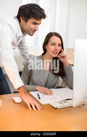 Male female business desk pc meeting Stock Photo