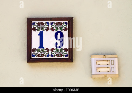 19 Numbered Tile As A Door Number With A Old Door Bell Stock Photo