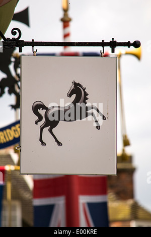 Black horse - Lloyds bank logo with the British flag in the background. Stock Photo