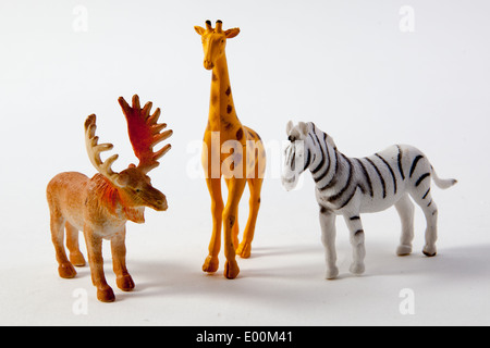 Plastic toys and figures from a play set, dinosaurs, farm animals and zoo animals Stock Photo