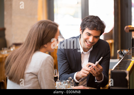 Man woman using cell phone coffee bar Stock Photo