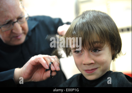 9 year old schoolboy having a haircut in barbers in Great Ayton, North Yorkshire, England uk Stock Photo