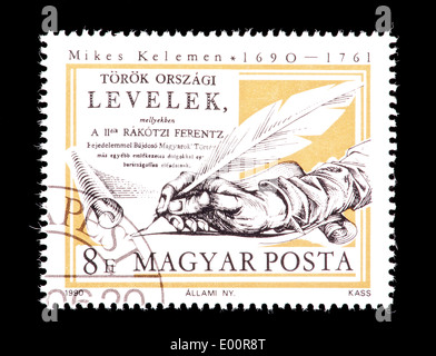 Postage stamp from Hungary depicting a writing hand, issued for the 300'th anniversary of the birth of Kelemen Mikes, Hungarian Stock Photo