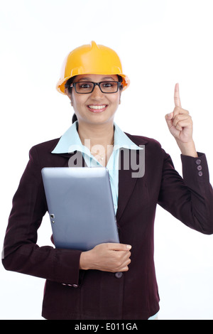 Young Indian female engineer with tablet against white background Stock Photo