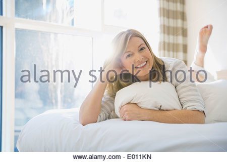 Portrait smiling barefoot woman in living room Stock Photo, Royalty ...