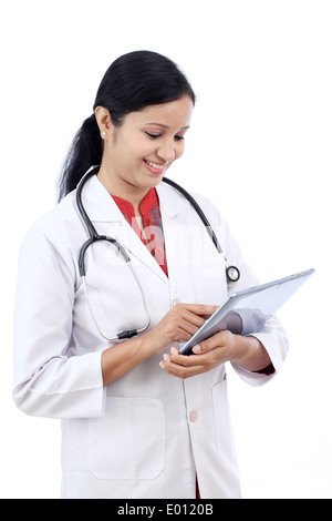 Young Asian female doctor using tablet device reviewing medical ...