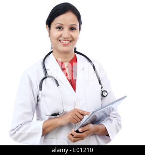 Young female doctor with tablet against white background Stock Photo