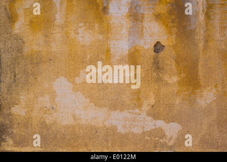 Abstract yellow wall background, a weathered, worn cement wall. Stock Photo