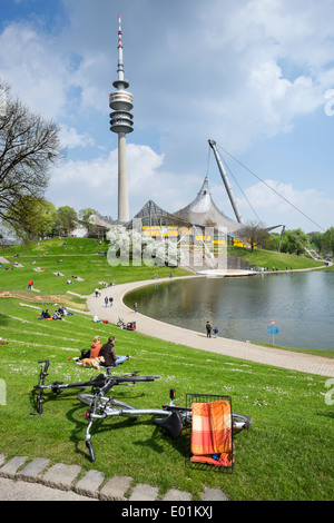 People outdoors in Spring weather at Olympic Park in Munich Bavaria Germany Stock Photo