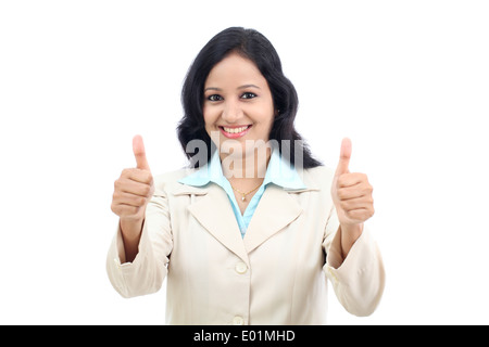 Smiling businesswoman showing thumbs up isolated against white background Stock Photo