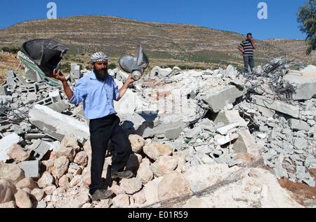 Nablus, Palestinian Territory. 29th Apr, 2014. A Palestinian man holds a damaged loudspeaker belonging to a mosque after they were demolished by Israeli bulldozers in Khirbet Al-Taweel village near the West Bank city of Nablus April 29, 2014. Israeli forces demolished several structures, including a mosque, in a Palestinian village on Tuesday. Credit:  Ayman Nobani/Xinhua/Alamy Live News Stock Photo