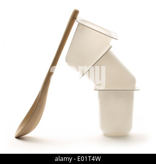 Empty plastic yogurt pots with wooden spoon Stock Photo