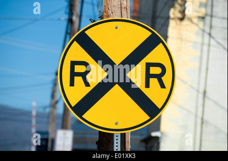 round railroad crossing road sign with blue sky background Stock Photo ...