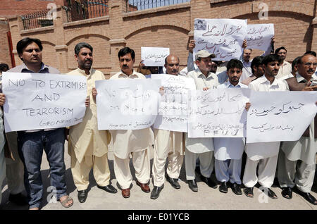 Members of Khyber Union of Journalists chant slogans against terrorist attack on senior journalist Hamid Mir during protest demonstration at Peshawar press club on Tuesday, April 29, 2014. Stock Photo