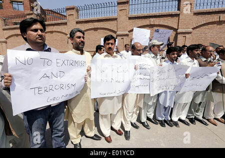 Members of Khyber Union of Journalists chant slogans against terrorist attack on senior journalist Hamid Mir during protest demonstration at Peshawar press club on Tuesday, April 29, 2014. Stock Photo