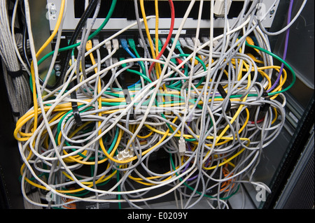 A lot of cables for internet on the back of a big computer Stock Photo