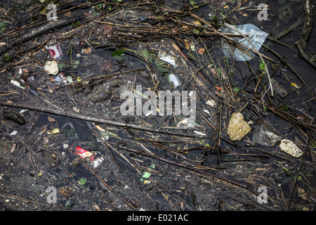 Plastic rubbish and other non-degradable waste in water of river Stock Photo