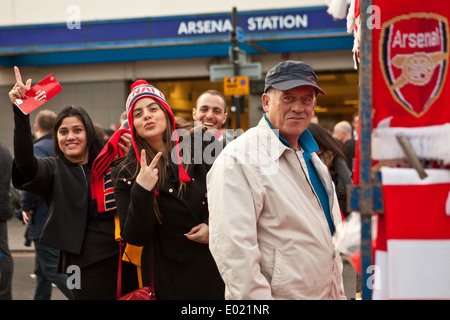 2 pretty female Arsenal fans on Gillespie Road outside Arsenal tube station Stock Photo