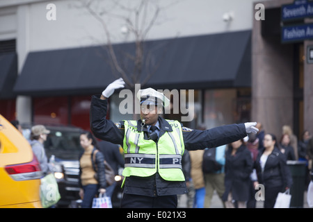 You have to keep your cool to be a traffic cop at 34th & Broadway by Macy's in NYC. Stock Photo