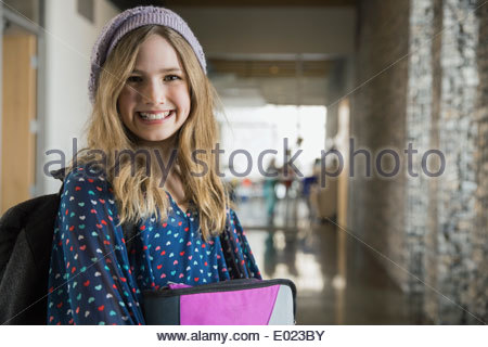 Portrait of confident school girl in corridor