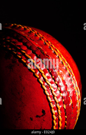 red ball cricket on a black background Stock Photo