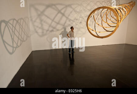 (140429) -- SANTIAGO, April 29, 2014 (Xinhua) -- A visitor watches the instalation 'Use and Abuse' of Chilean artist Patrick Steeger, at the Contemporary Art Museum in Santiago, capital of Chile, on April 29, 2014. The artist presents big instalations, sculptures, objects and prototypes displayed as a result of an alliance of three years between the artist and the forestry cellulose company Arauco. (Xinhua/Jorge Villegas) Stock Photo