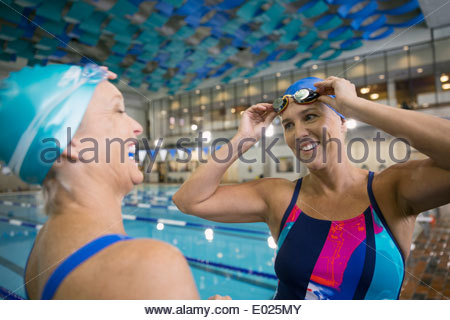 Women talking at indoor swimming pool