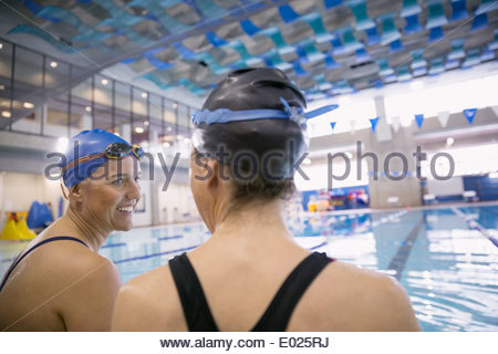 Women talking at indoor swimming pool
