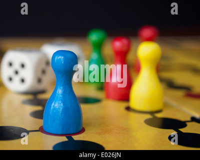 Close up of colorful wooden pins and dices on a classic board game Stock Photo