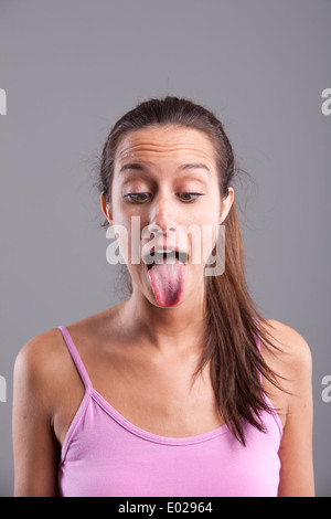 Funny pretty girl with the tongue stuck out Stock Photo