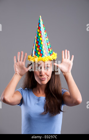 Party clown hat girl showing funny faces Stock Photo