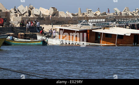 Gaza, Gaza City. 29th Apr, 2014. Palestinians inspect the Gaza's Ark, a Palestinian-built protest boat which was preparing to run Israel's naval blockade, after it was damaged in an explosion at the port in Gaza City, on April 29, 2014. In the early hours of Tuesday morning, activists from Freedom Flotilla Coalition who are responsible for the Gaza's Ark boat received a call to leave the vessel because it was going to be attacked. A few minutes later, a large explosion rocked the boat, causing extensive damage. © Yasser Qudih/Xinhua/Alamy Live News Stock Photo