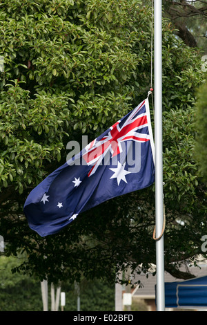 Australian flag at half mast during ANZAC day service Stock Photo
